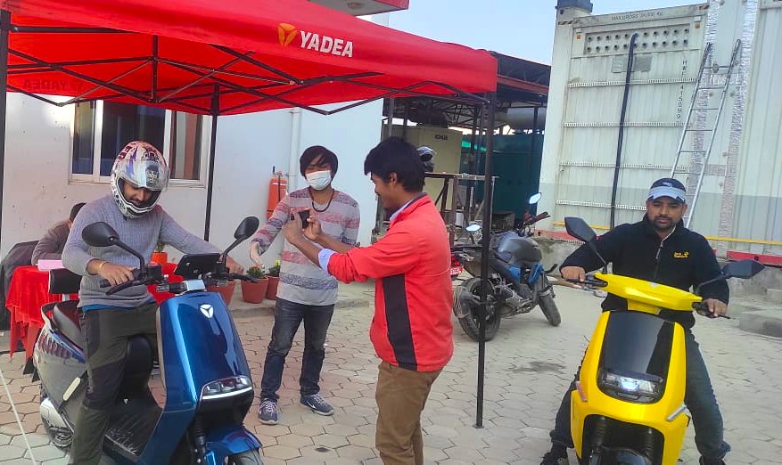 People test riding Yadea e-scooter