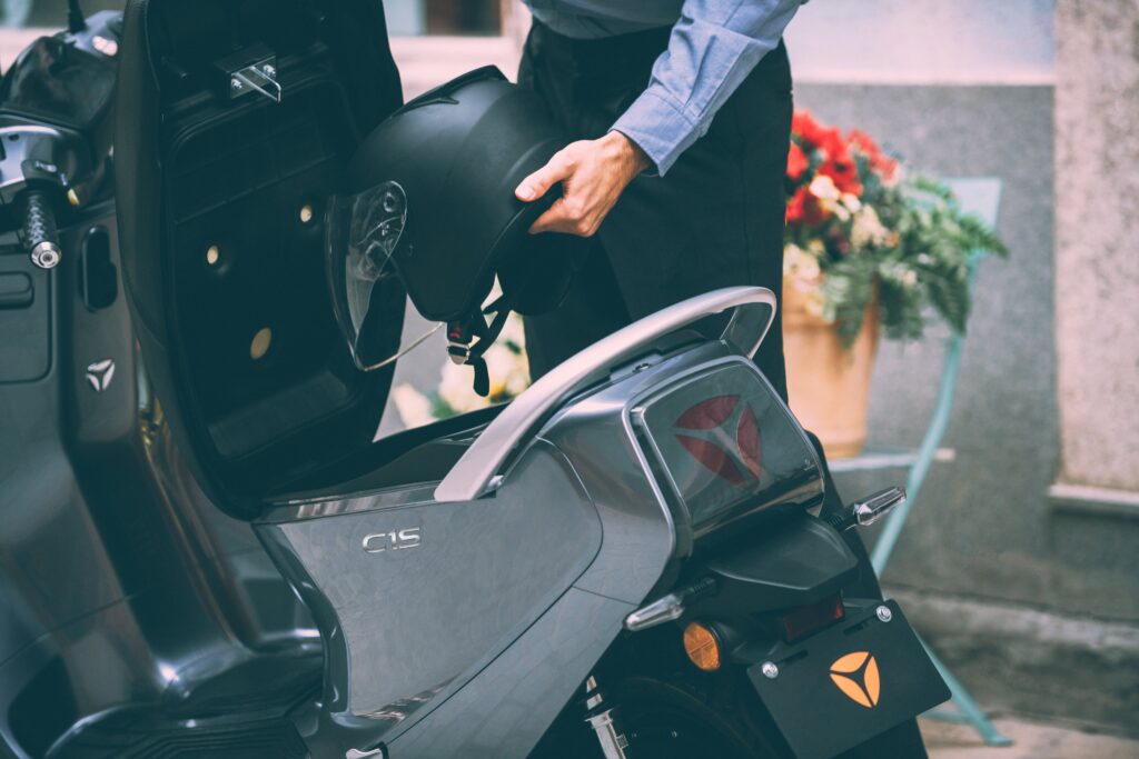 Man preparing to ride Yadea electric scooter
